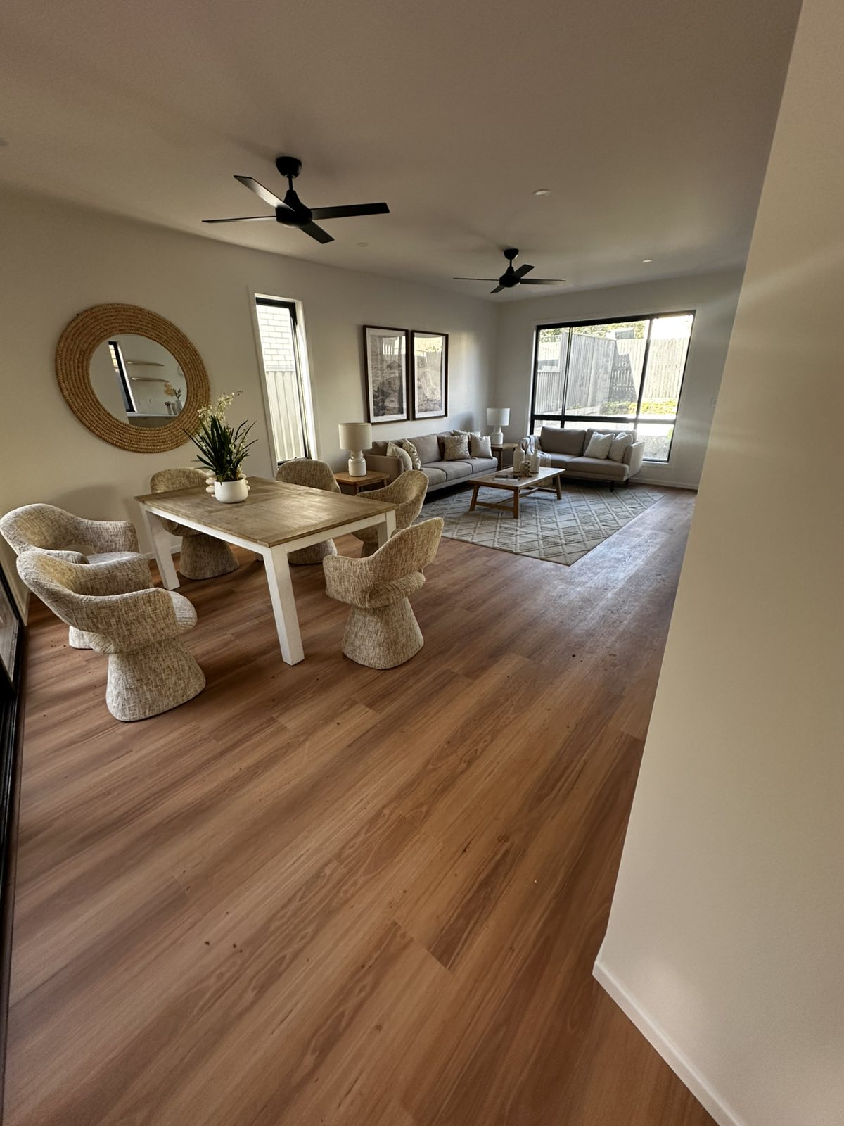Open-plan living and dining area with timber flooring and dining table